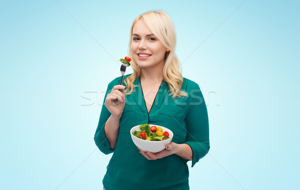 Stock photo: smiling young woman eating vegetable salad