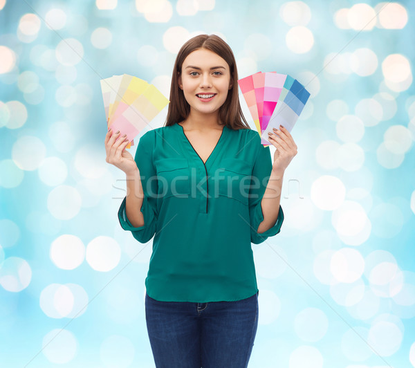 smiling young woman with color swatches Stock photo © dolgachov