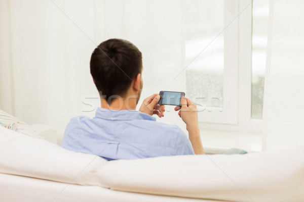 close up of man with smartphone at home Stock photo © dolgachov