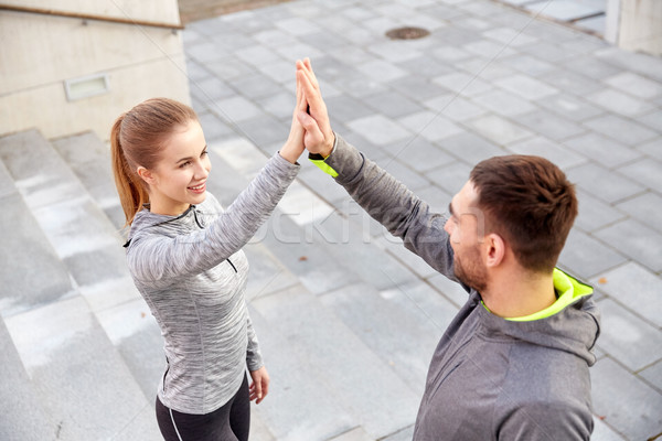 улыбаясь пару high five городской улице фитнес Сток-фото © dolgachov