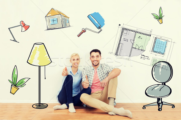 happy couple showing thumbs up at new home Stock photo © dolgachov