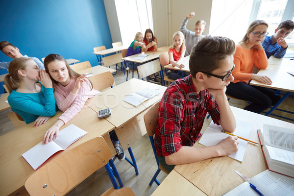 students gossiping behind classmate back at school Stock photo © dolgachov