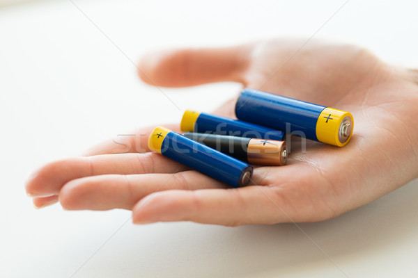 close up of hands holding alkaline batteries heap Stock photo © dolgachov