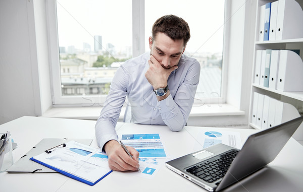 Stock photo: stressed businessman with papers in office