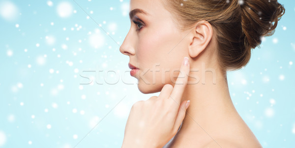 Stock photo: close up of woman pointing finger to ear over snow