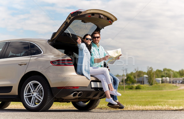 happy man and woman with road map at hatchback car Stock photo © dolgachov