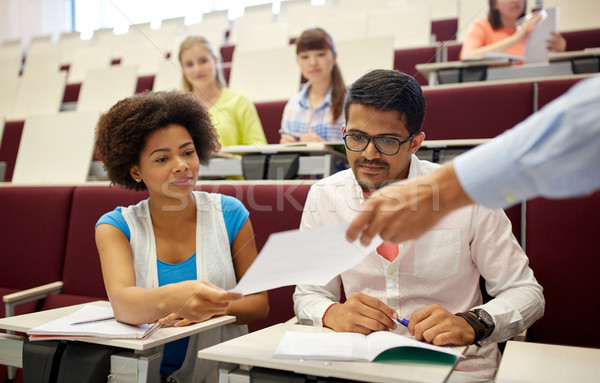 Stock photo: teacher giving tests to students at lecture