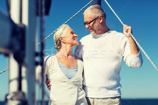 senior couple hugging on sail boat or yacht in sea Stock photo © dolgachov