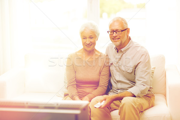 happy senior couple watching tv at home Stock photo © dolgachov