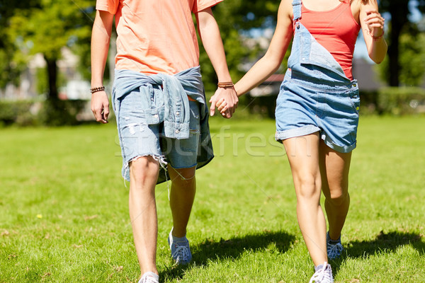 happy teenage couple walking at summer park Stock photo © dolgachov
