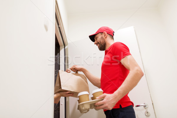 man delivering coffee and food to customer home Stock photo © dolgachov