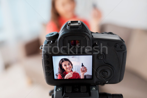 woman with foundation and camera recording video Stock photo © dolgachov
