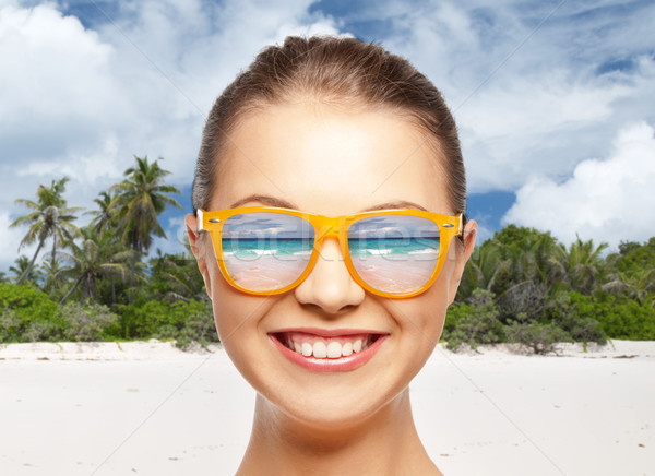 happy smiling teenage girl in shades over beach Stock photo © dolgachov