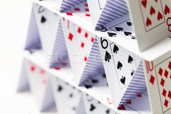 house of playing cards over white background Stock photo © dolgachov