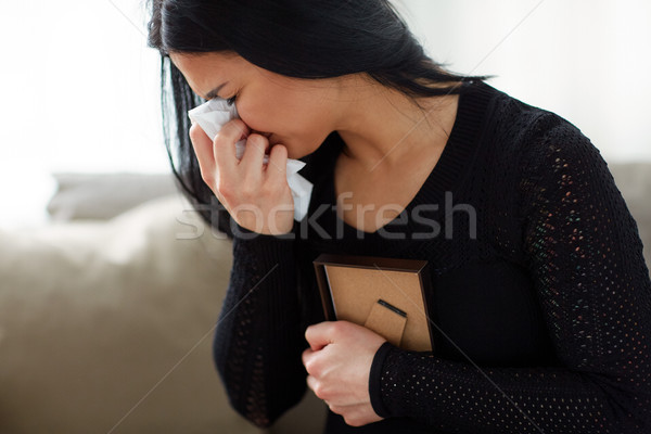 crying woman with photo frame at funeral day Stock photo © dolgachov