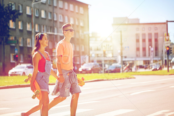 teenage couple with skateboards on city street Stock photo © dolgachov