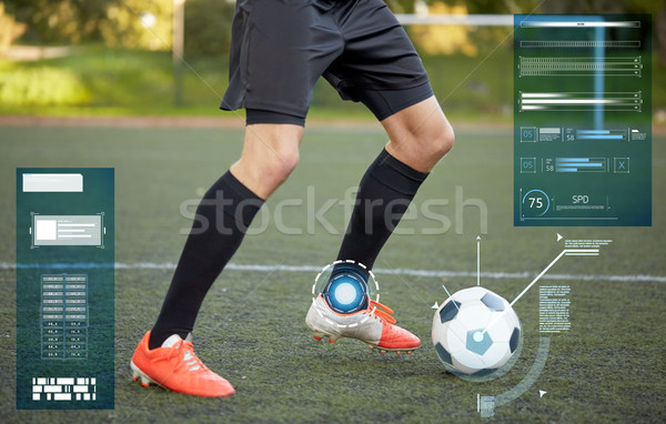 soccer player playing with ball on football field Stock photo © dolgachov