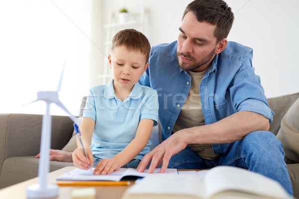 father and son with toy wind turbine at home Stock photo © dolgachov