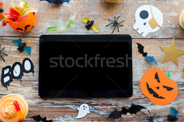 tablet pc, halloween party decorations and treats Stock photo © dolgachov