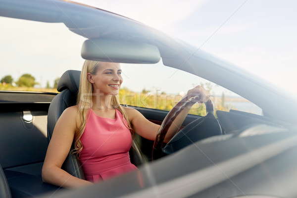 happy young woman driving convertible car Stock photo © dolgachov
