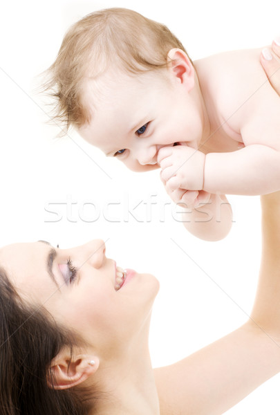 Stock photo: laughing blue-eyed baby playing with mom