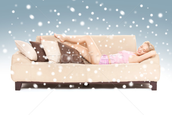 sleeping woman on sofa with snow Stock photo © dolgachov