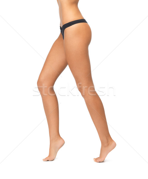 Női lábak fekete bikini bugyik kép Stock fotó © dolgachov
