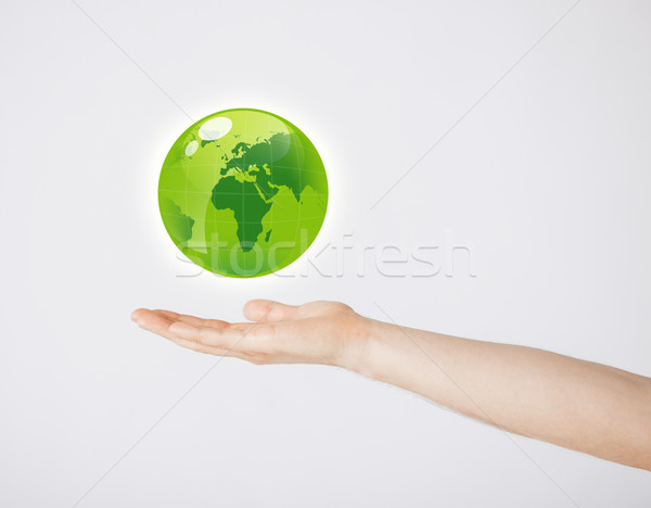 mans hand holding green globe Stock photo © dolgachov