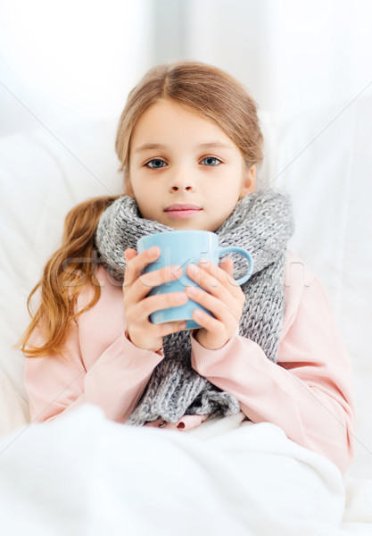 ill girl child with cup of hot tea Stock photo © dolgachov