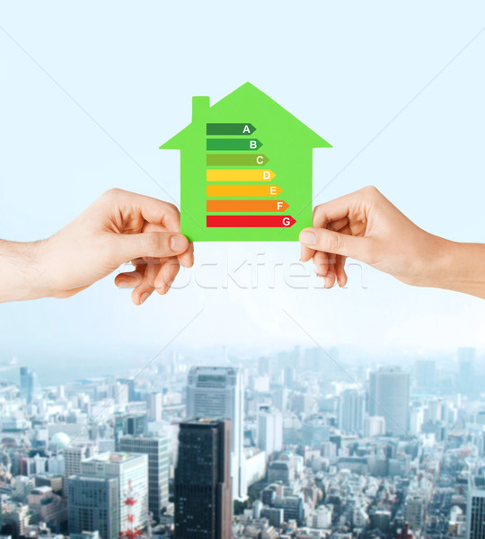 Stock photo: hands holding green paper house