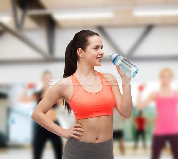 sporty woman with water bottle Stock photo © dolgachov
