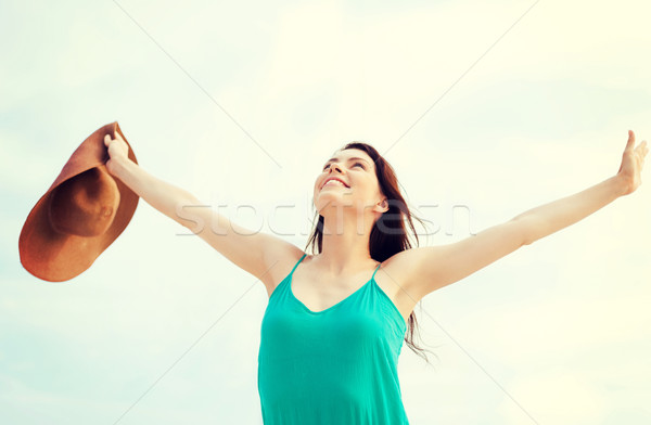 girl with hands up on the beach Stock photo © dolgachov