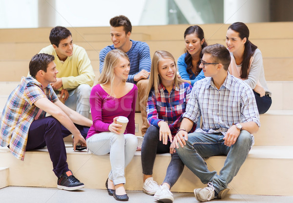 group of smiling students with paper coffee cups Stock photo © dolgachov