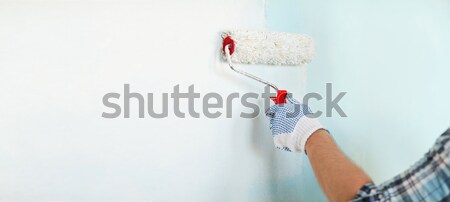 close up of male in gloves painting wall Stock photo © dolgachov