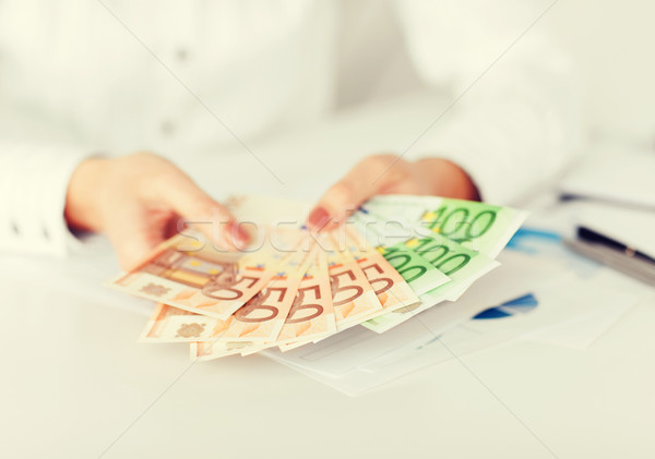 Nő kezek Euro pénz pénz üzlet Stock fotó © dolgachov