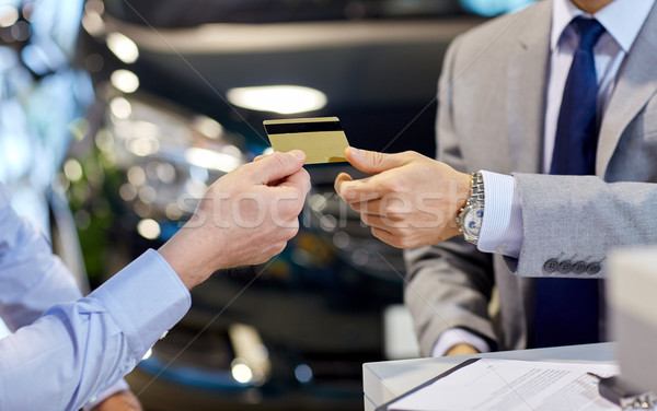 customer giving credit card to car dealer in salon Stock photo © dolgachov