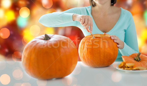 close up of woman carving pumpkins for halloween Stock photo © dolgachov