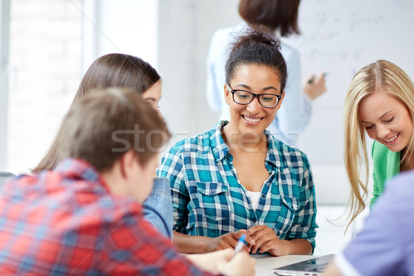 group of happy high school students with workbook Stock photo © dolgachov