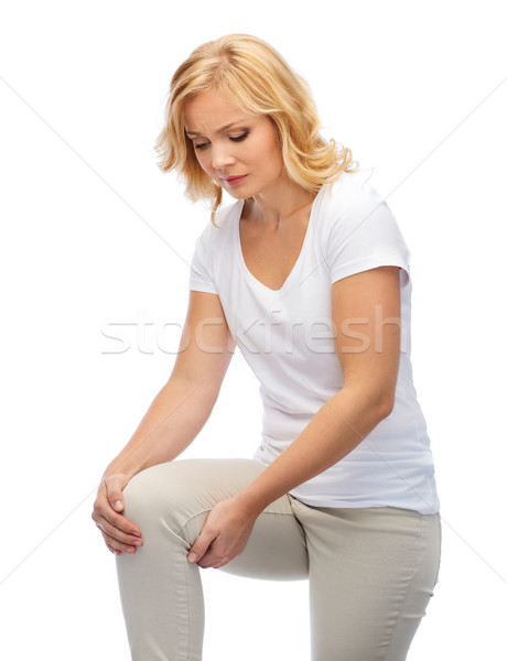 unhappy woman suffering from pain in leg at home Stock photo © dolgachov