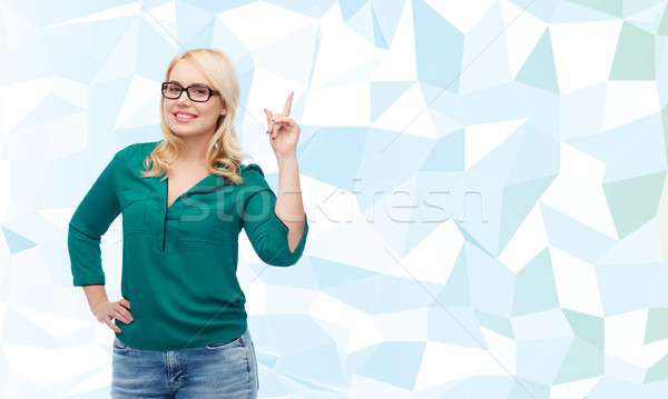 Jonge vrouw bril wijzend vinger omhoog visie Stockfoto © dolgachov