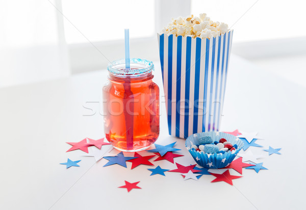 drink and popcorn with candies on independence day Stock photo © dolgachov