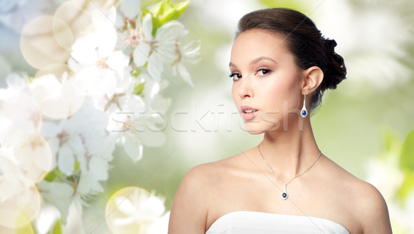 beautiful asian woman with earring and pendant Stock photo © dolgachov