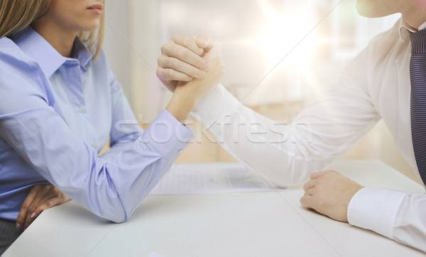 businesswoman and businessman arm wrestling Stock photo © dolgachov