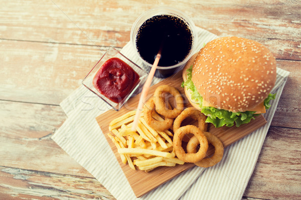 close up of fast food snacks and drink on table Stock photo © dolgachov