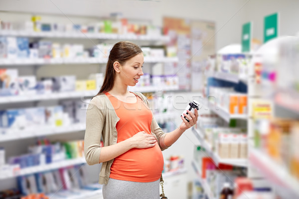 happy pregnant woman with medication at pharmacy Stock photo © dolgachov