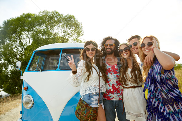 hippie friends over minivan car showing peace sign Stock photo © dolgachov