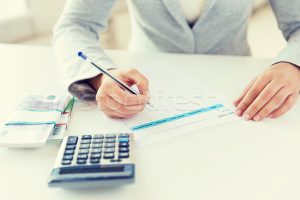 close up of hands counting money with calculator Stock photo © dolgachov
