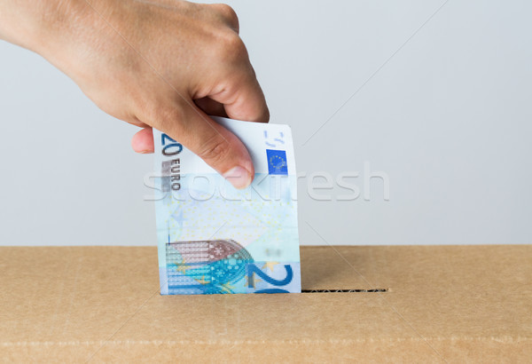 man putting euro money into donation box Stock photo © dolgachov