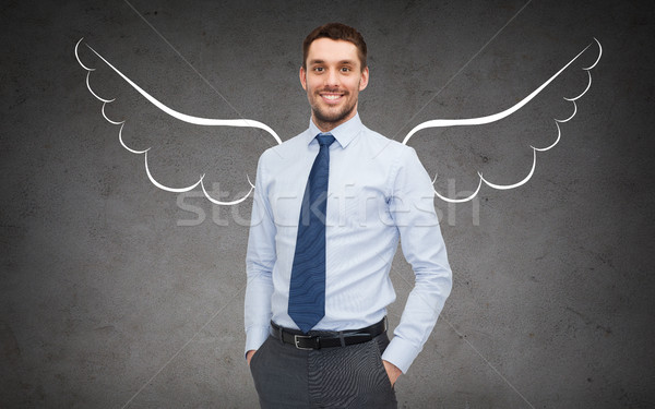 happy businessman with angel wings over gray Stock photo © dolgachov
