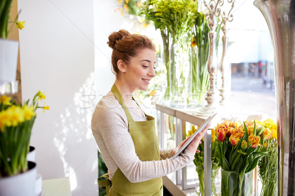 woman with tablet pc computer at flower shop Stock photo © dolgachov